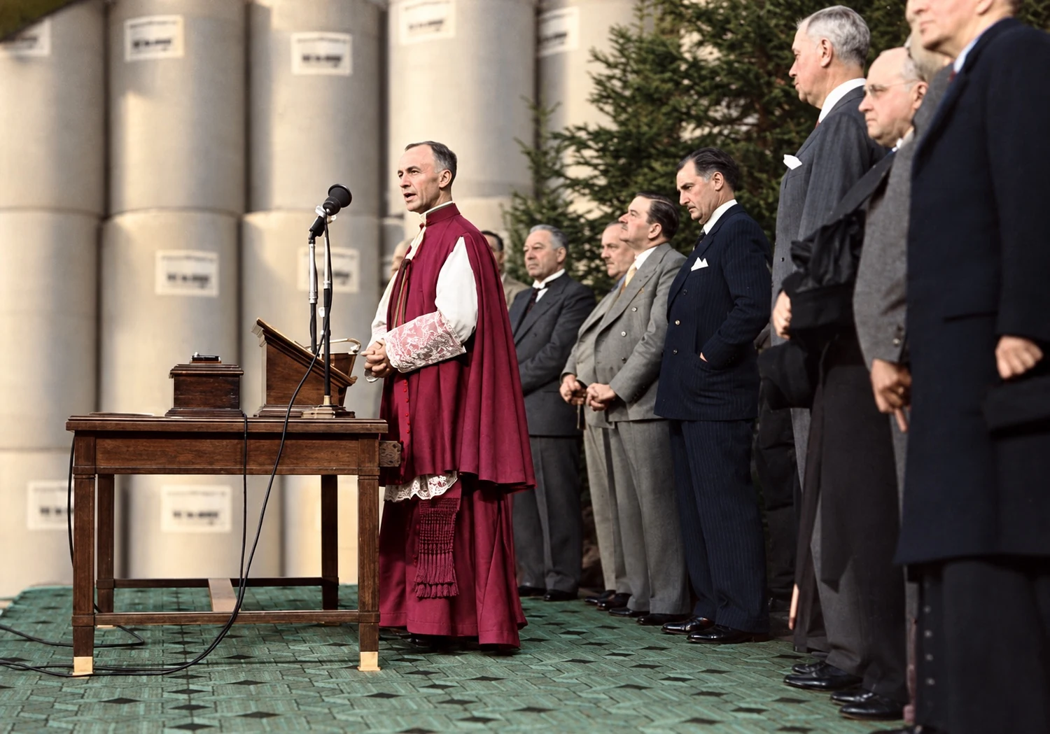 Mgr Napoléon-Alexandre Labrie delivers a speech during a ceremony, surrounded by dignitaries