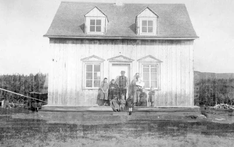 Labrie family in front of a house in Godbout