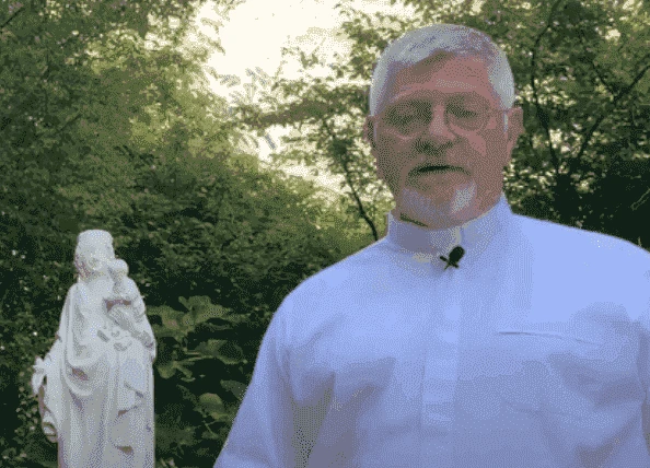 Jean-Michel Amouriaux junto a una estatua de san José
